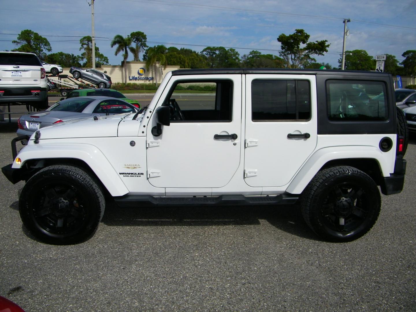 2015 White /Black Jeep Wrangler Unlimited Sahara 4WD (1C4BJWEGXFL) with an 3.6L V6 DOHC 24V FFV engine, Automatic transmission, located at 4000 Bee Ridge Road, Sarasota, FL, 34233, (941) 926-0300, 27.298664, -82.489151 - Photo#2